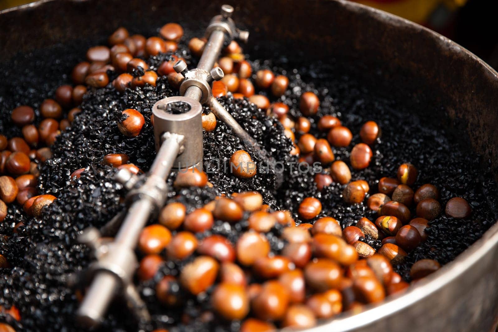 Rotating Roasting Chestnuts on Coal for snacking