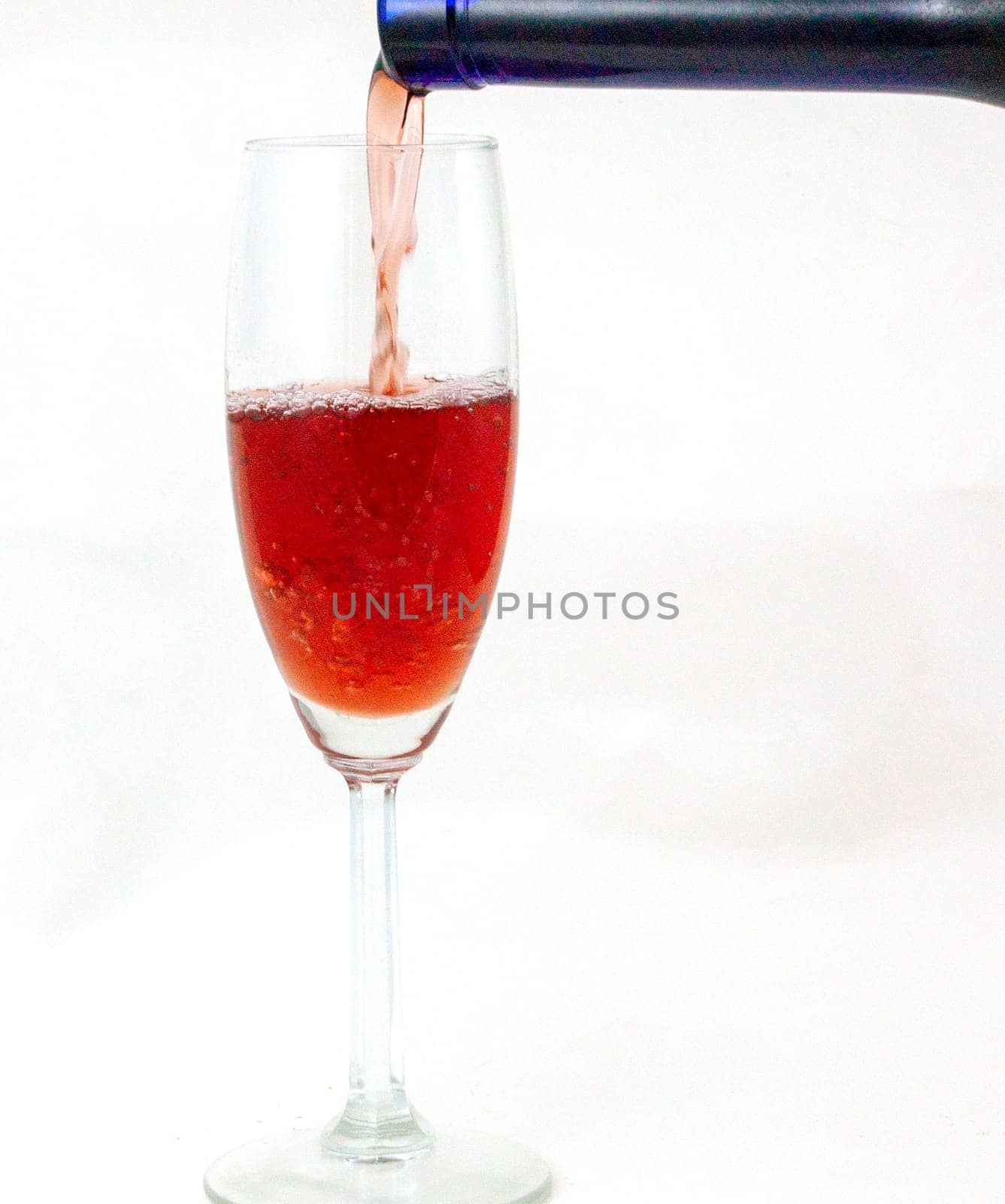 Pouring Dessert Wine in flute from a blue bottle