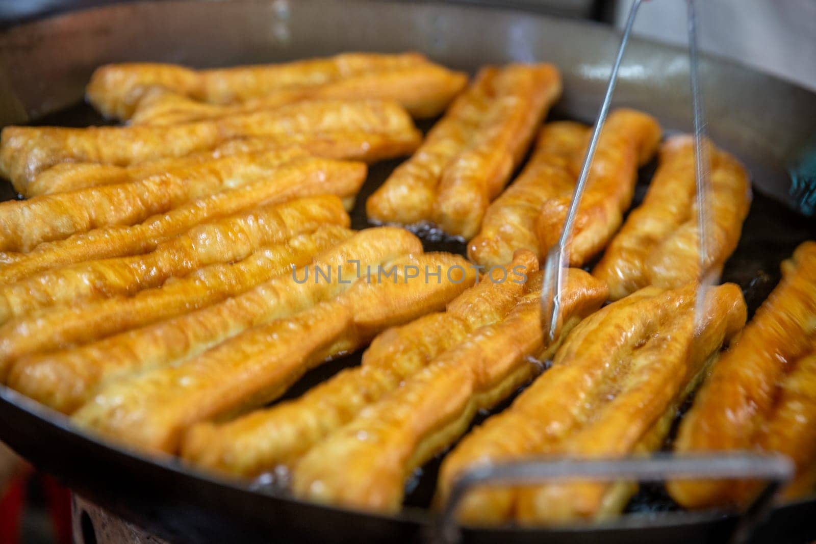 Frying fresh chinese donuts at the market