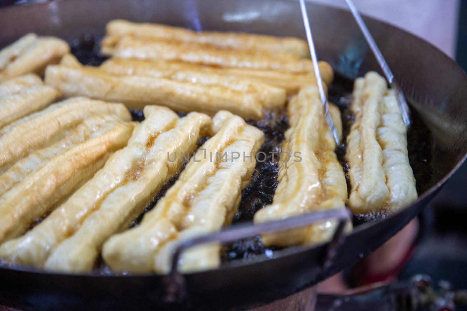 Frying Chinese Donuts as Street Food in asia