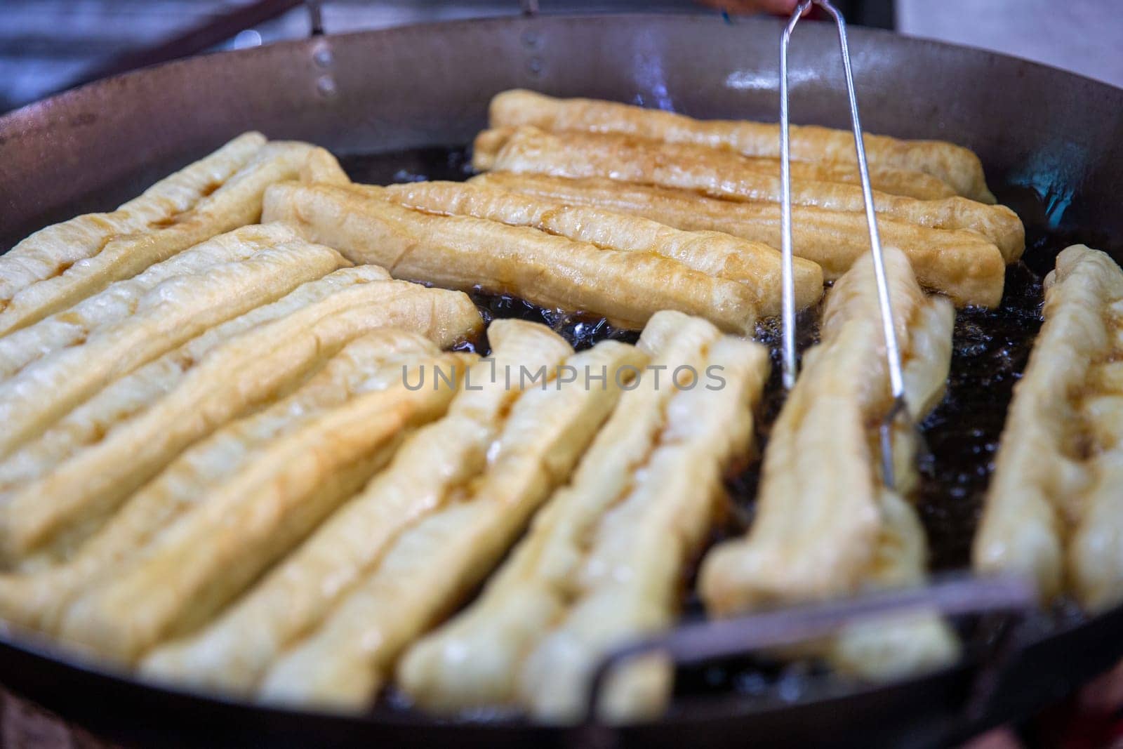 Frying Chinese Donuts as Street Food in asia