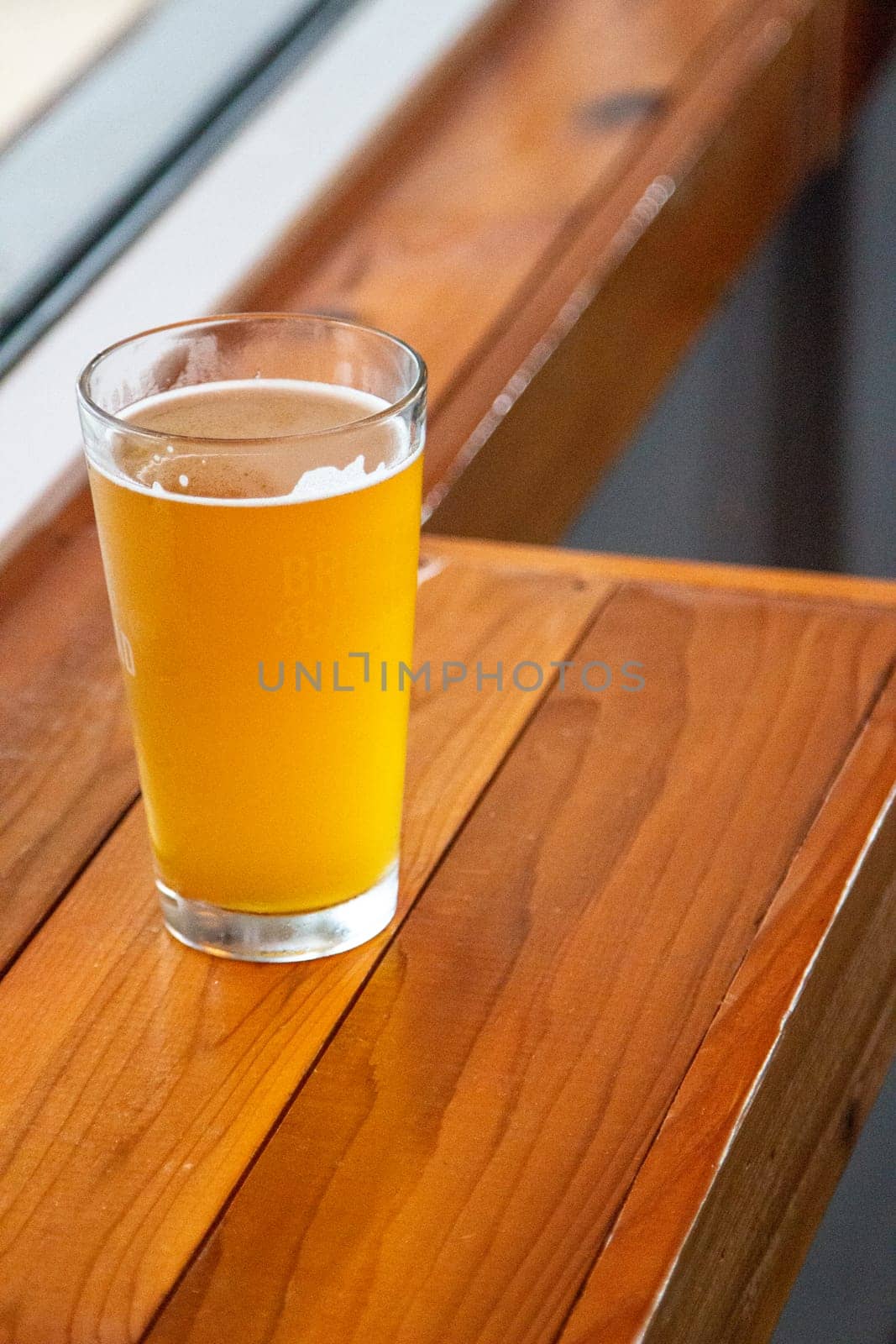 Filled Pint Of Beer By The Window