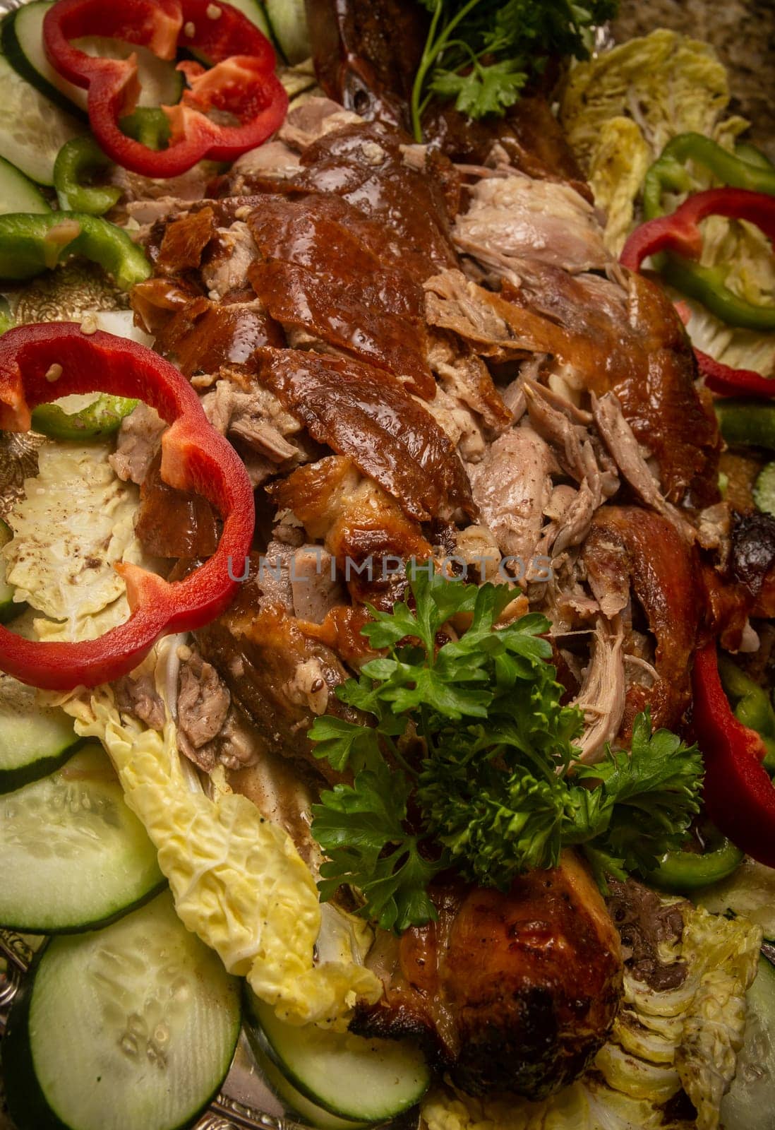 Shredded Peking Duck on a platter with vegetables