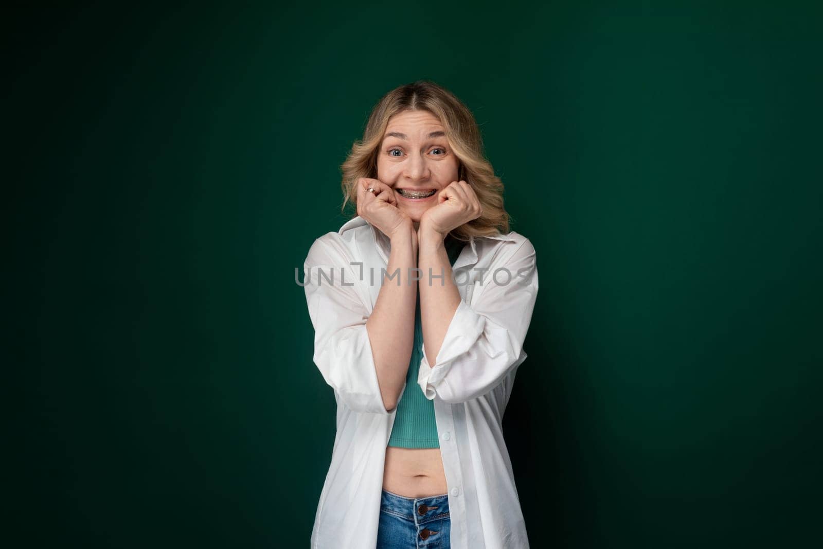Woman Posing in Front of Green Background by TRMK