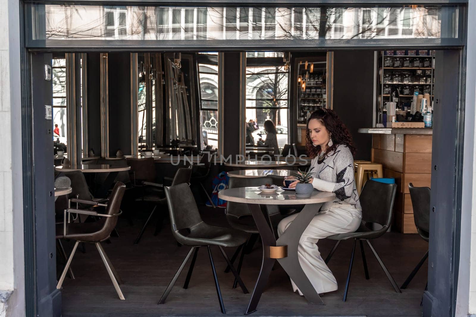 Woman cafe coffee breakfast. Portrait of an adult beautiful woman in an elegant suit in a cafe by Matiunina