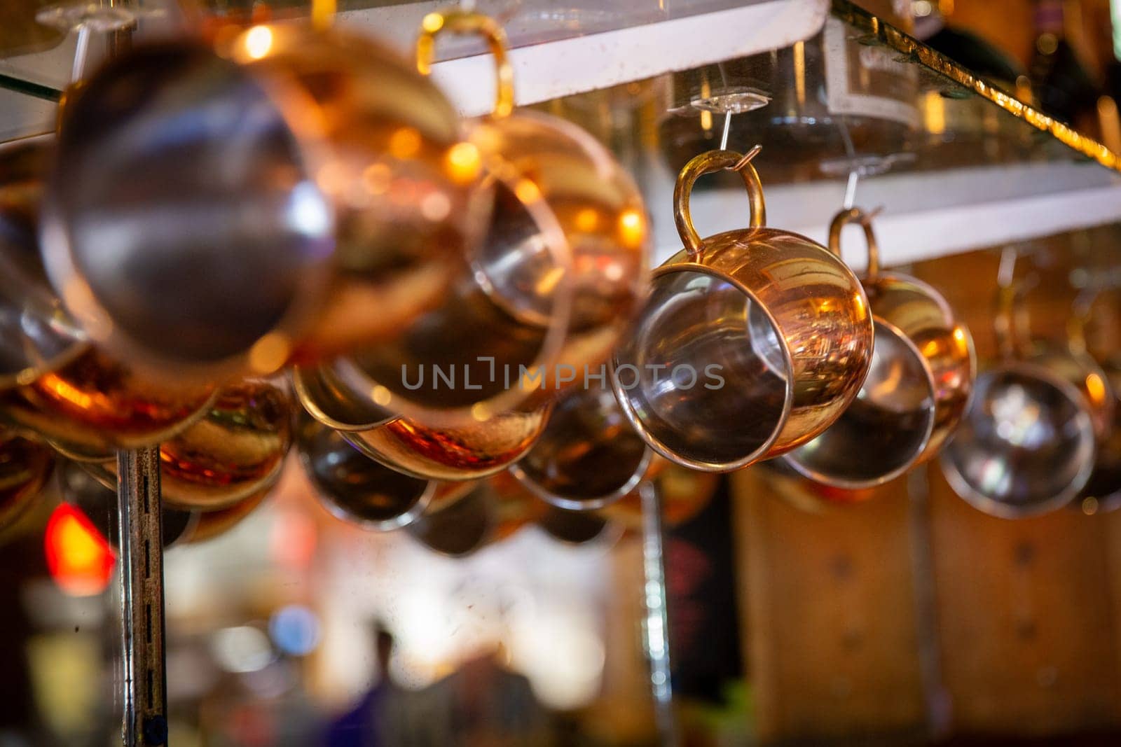 Moscow mule cups hanging at a bar