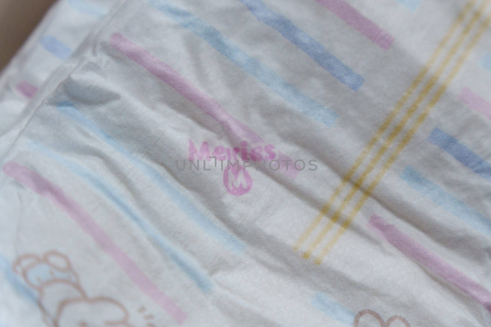 Tyumen, Russia-March 02, 2024: Detailed close-up of a bag of Merries baby diapers, showcasing the brand logo and packaging design. by darksoul72