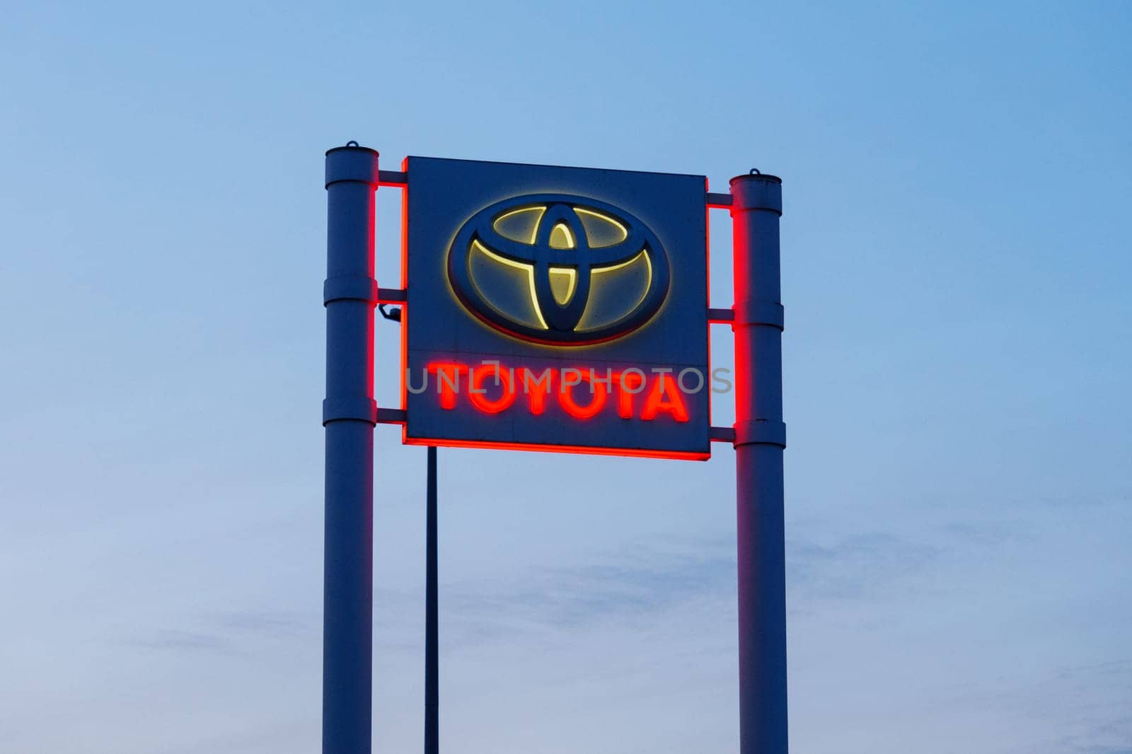 Tyumen, Russia-March 02, 2024: Toyota sign standing prominently against a clear blue sky, showcasing the iconic brand logo by darksoul72