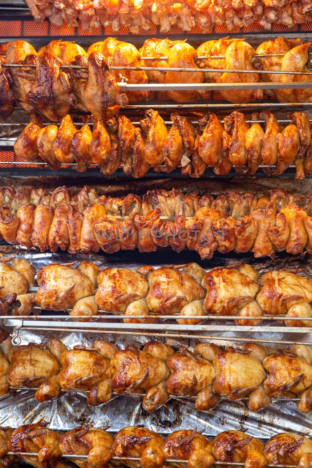 Rotisserie chicken on a rack roasting