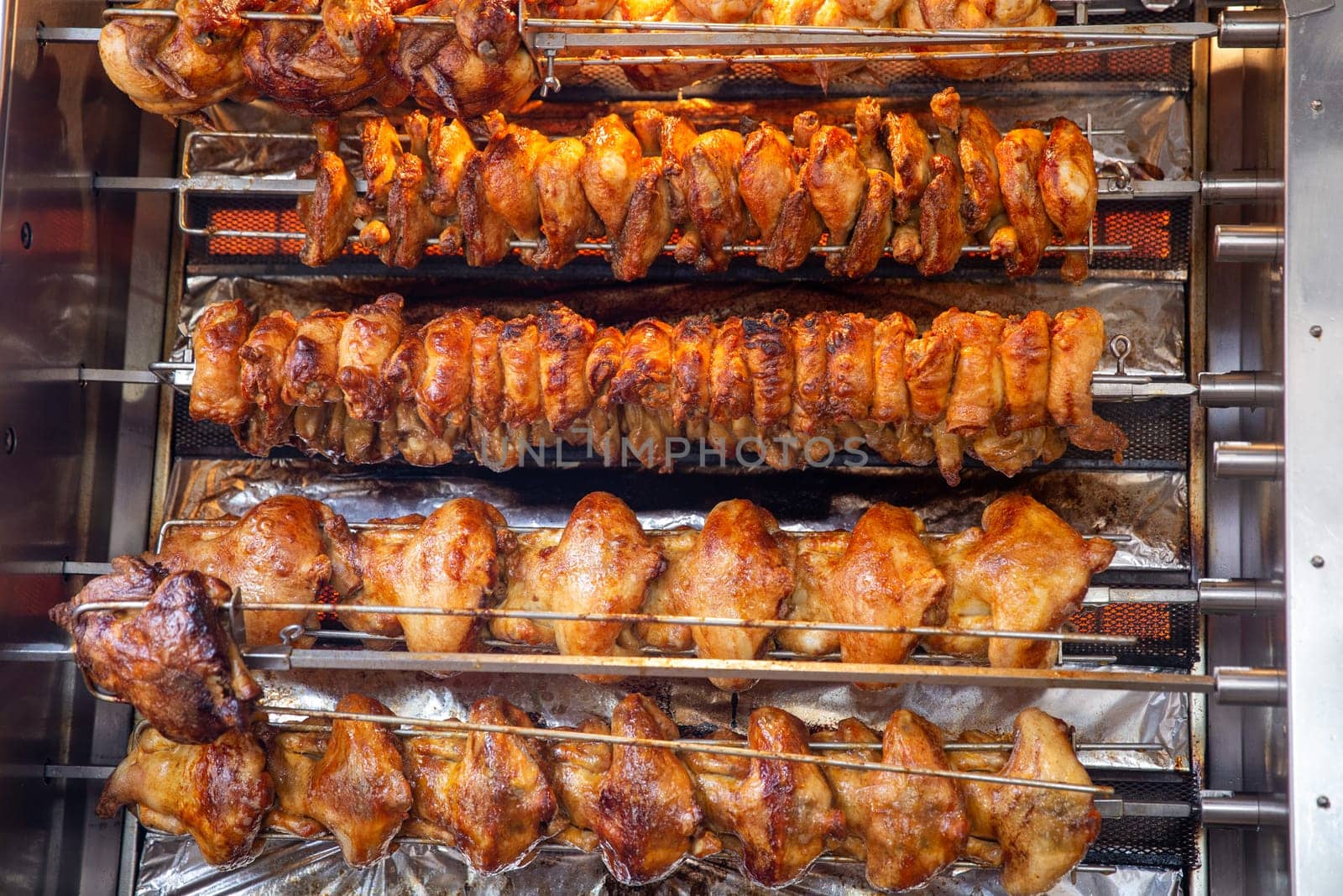 Rotisserie chicken on a rack roasting