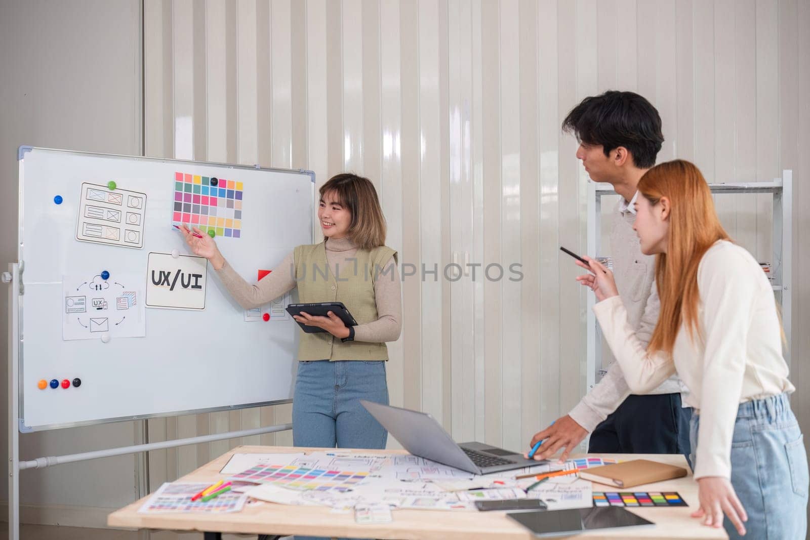 Creative team of designers in application design and ux ui usability planning. Modern business team teamwork. by wichayada