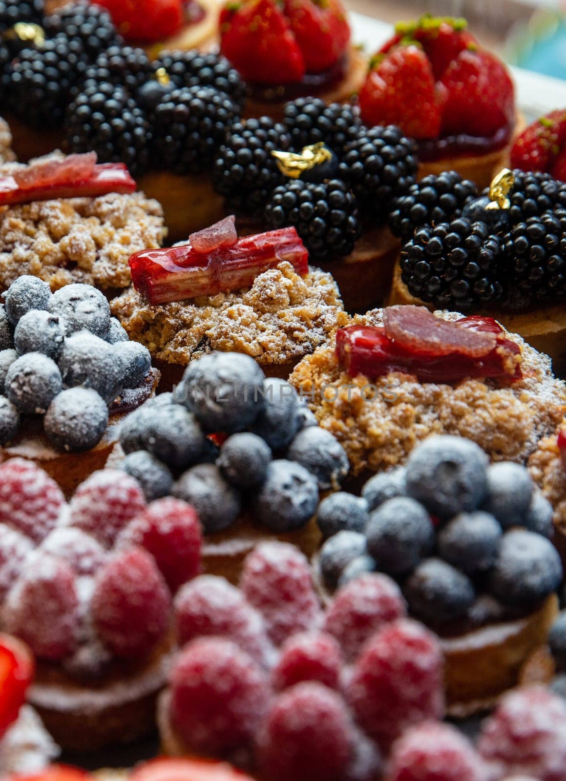 Various Petite Vibrant Fruit Tarts a a bakery