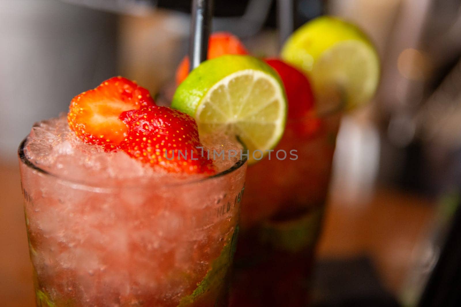 Two strawberry drinks at a bar to drink