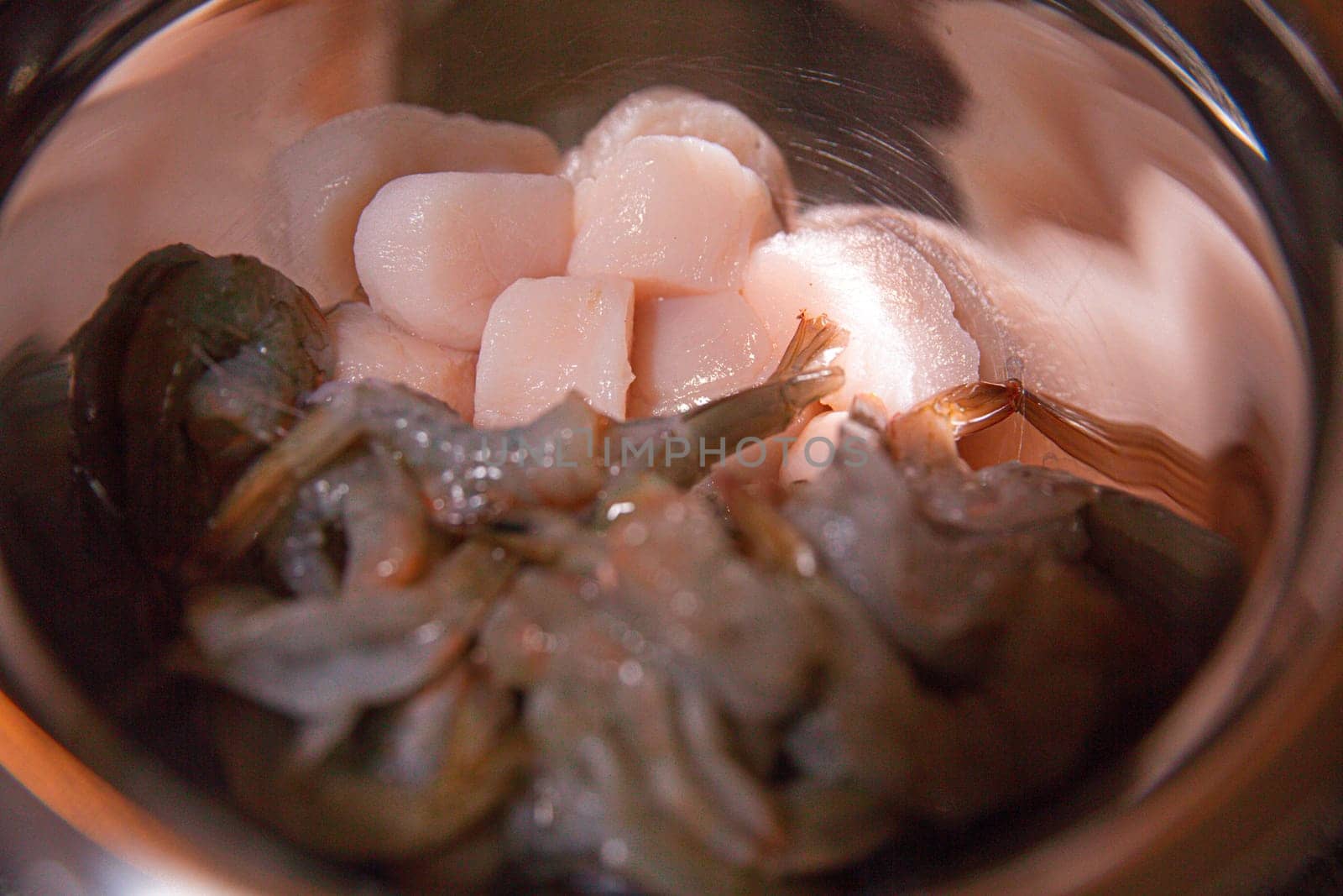 Raw shrimp and Scallops in a bowl to be cooked