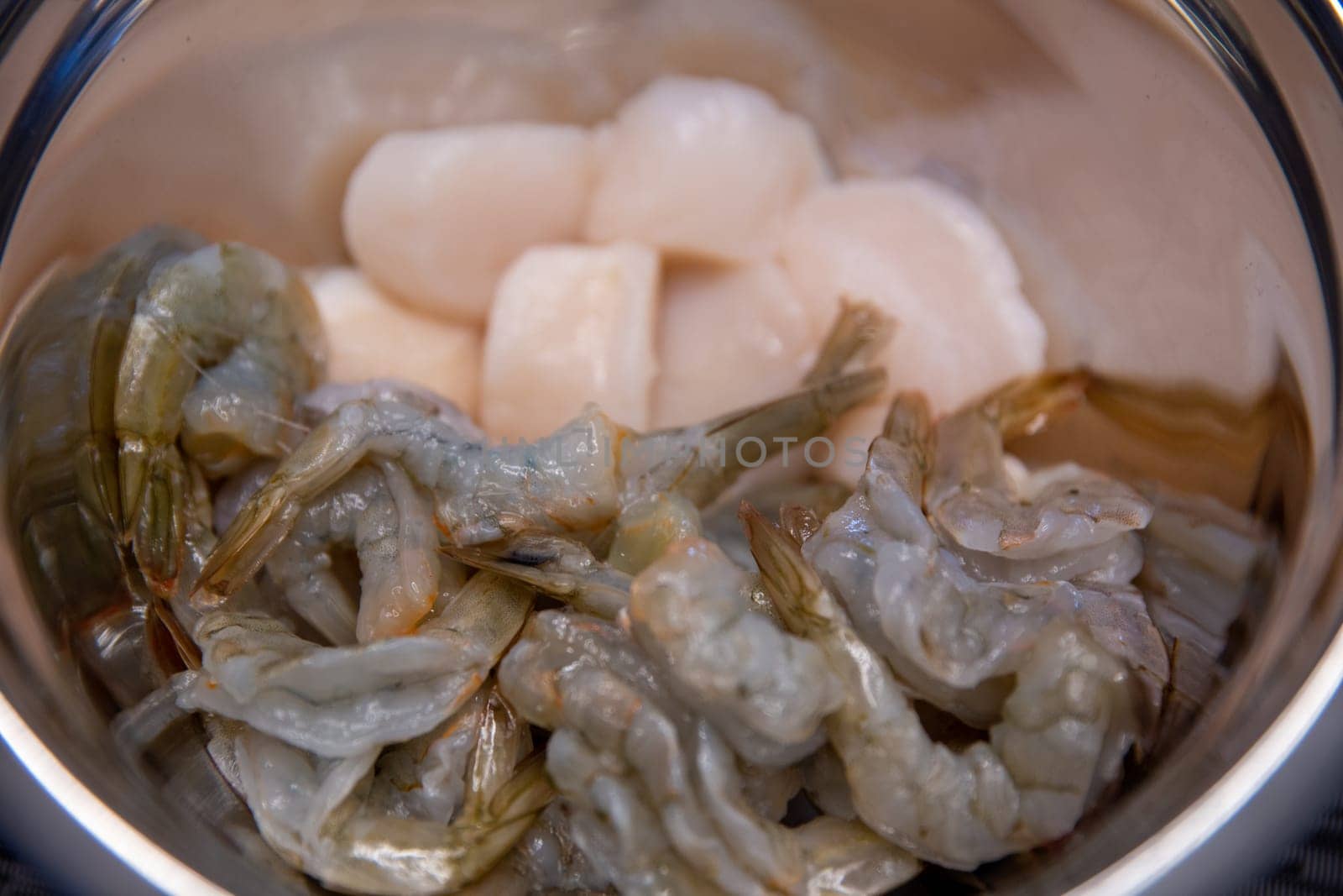 Raw shrimp and Scallops in a bowl to be cooked