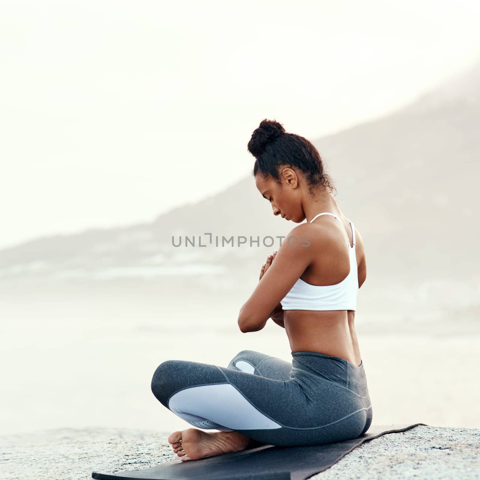 Fitness, meditation and yoga with woman on beach for mental health, peace or wellness in morning. Exercise, training and zen with sporty person on mat at coast by ocean or sea for balance and mindset.