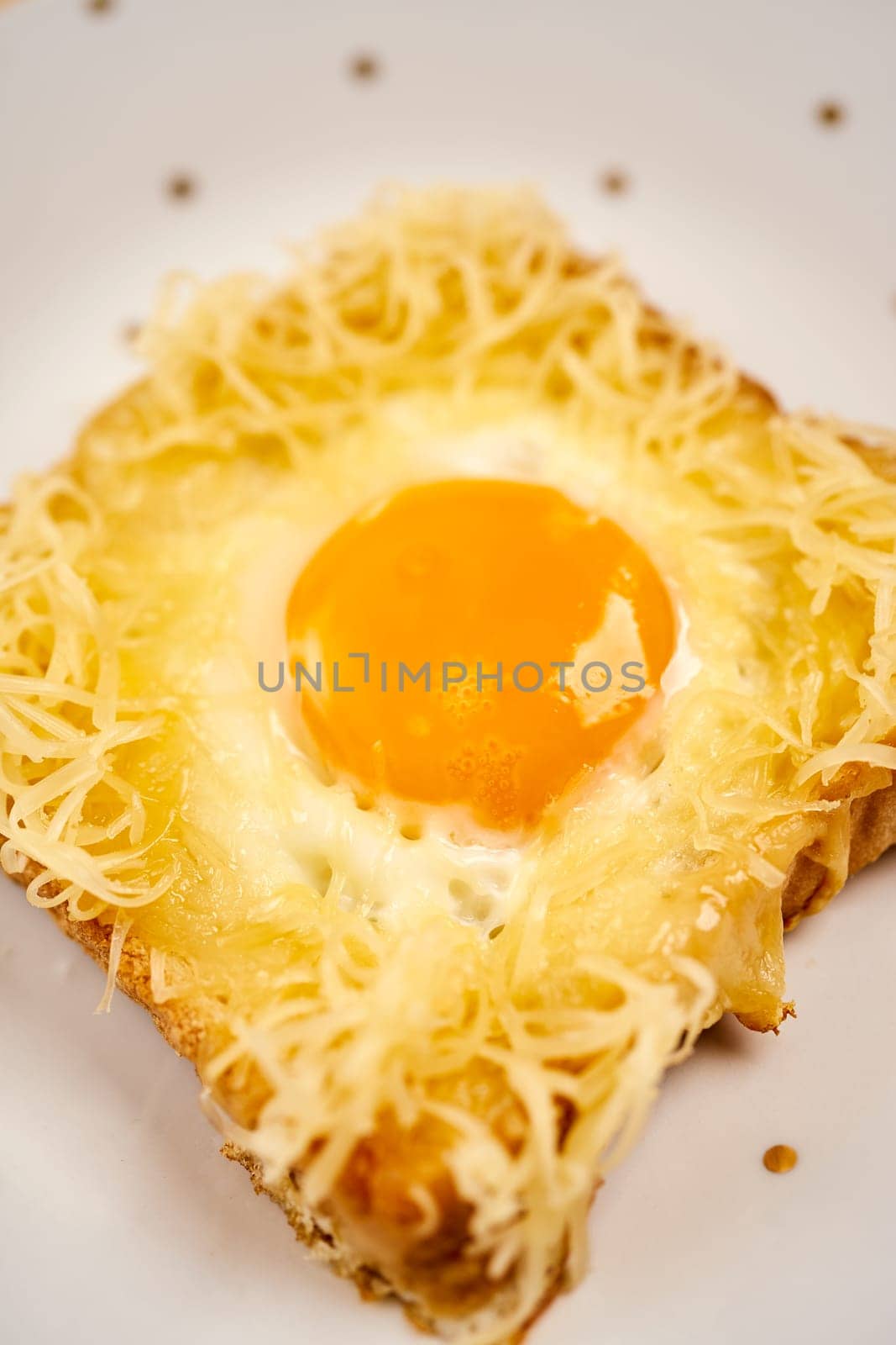 Delicious toast with fried egg on wooden kitchen table by superstellar