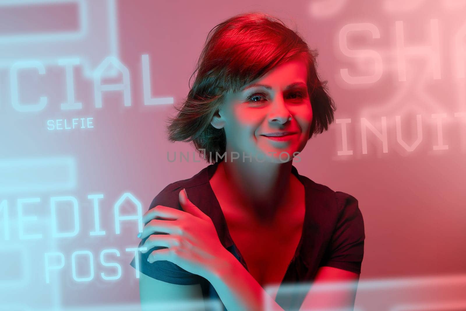 Beautiful attractive young woman posing in neon light in studio by superstellar