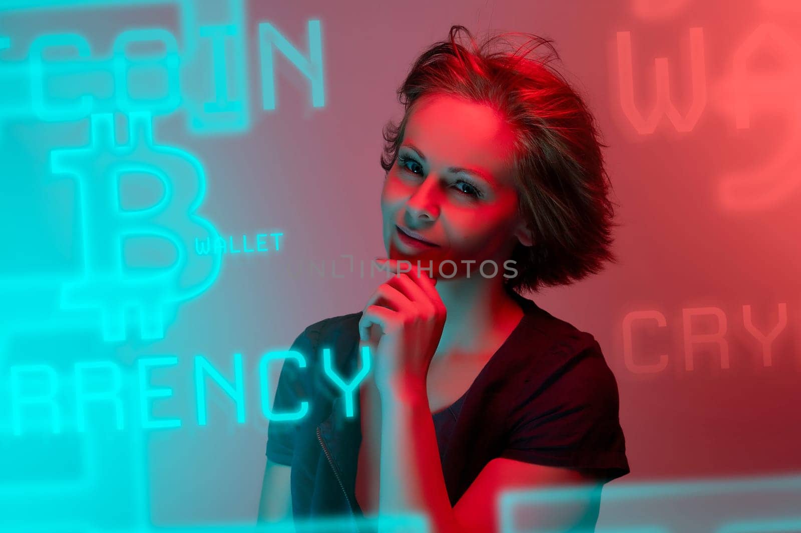 Beautiful attractive young woman posing in neon light in studio by superstellar