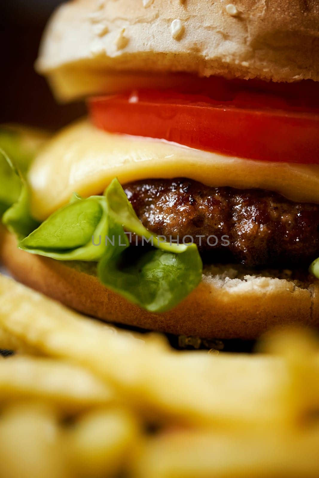 delicious cheeseburger on a black table with salt crystals