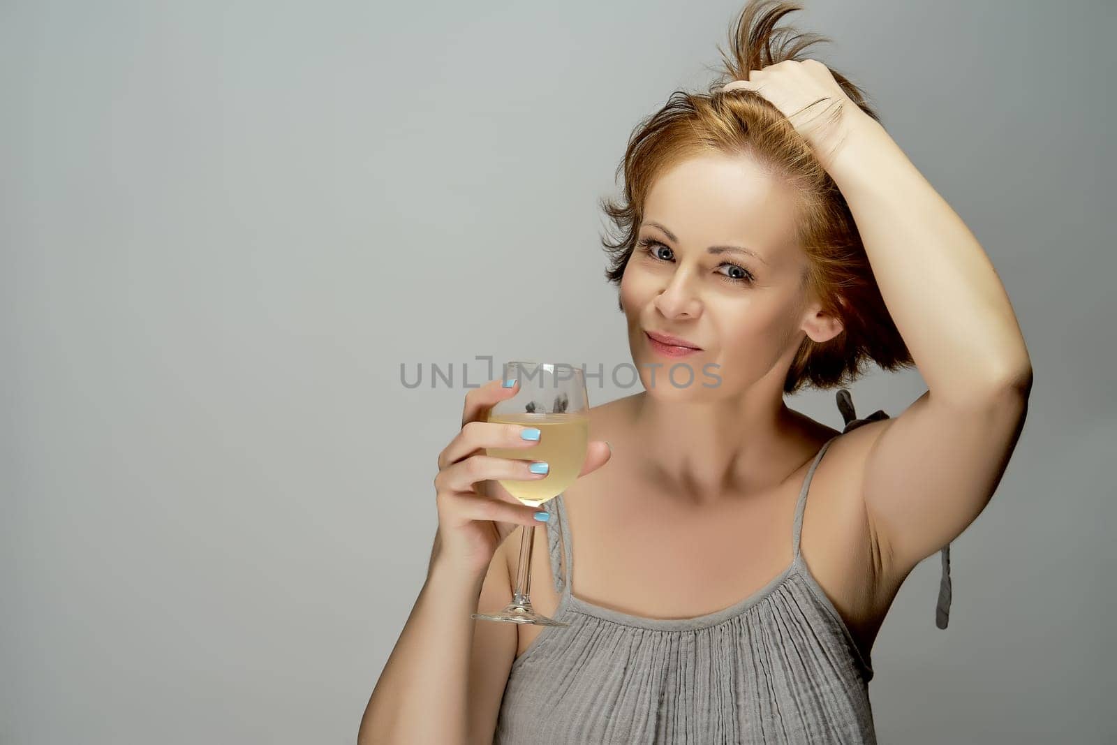 Portrait of attractive red-haired woman with a glass of white wine by superstellar