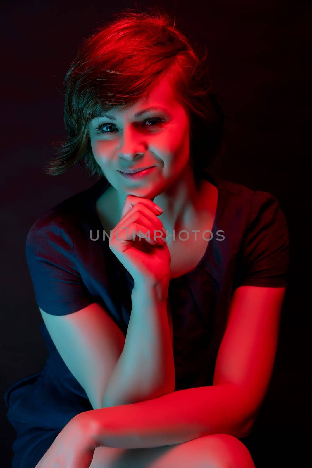 Beautiful attractive young woman posing in neon light in the studio