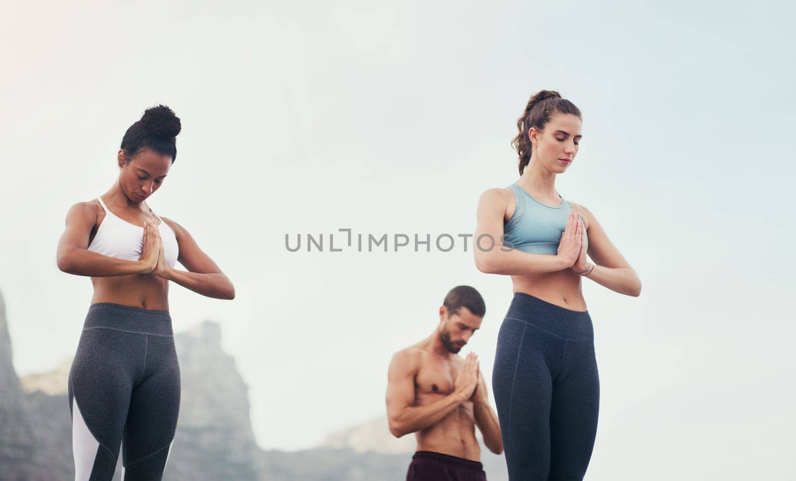 Yoga, namaste meditation and group outdoor for fitness, mindfulness and peace on sky mockup space. Prayer hands, class and calm in nature for exercise, zen and wellness for healthy body in summer by YuriArcurs