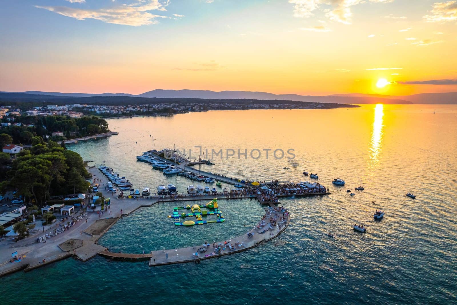 Malinska waterfront beach and turquoise coastline sunset view, Island of Krk tourist destination in Croatia