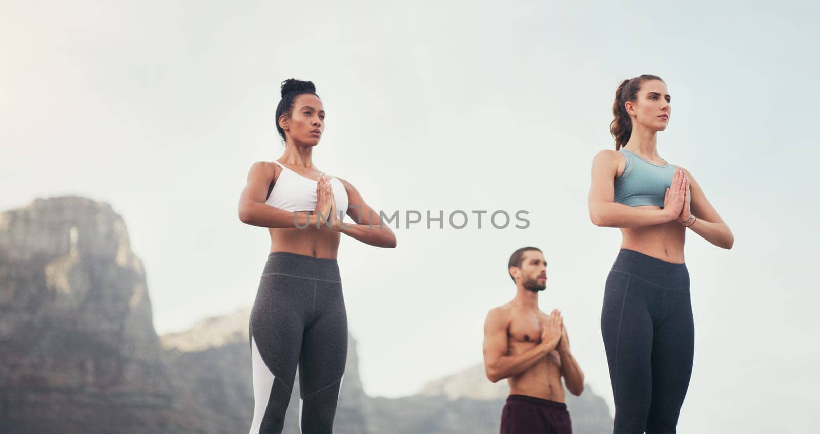 Yoga, namaste and group outdoor for fitness, mindfulness and peace on sky mockup space. Prayer hands, class and calm people in nature together for exercise, zen or wellness for healthy body in summer.