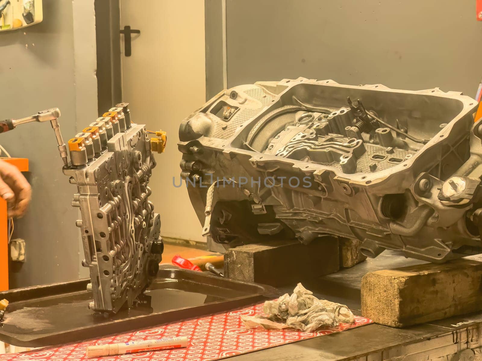 Close-up of mechanical repairs on an automatic gearbox during servicing or refurbishment.