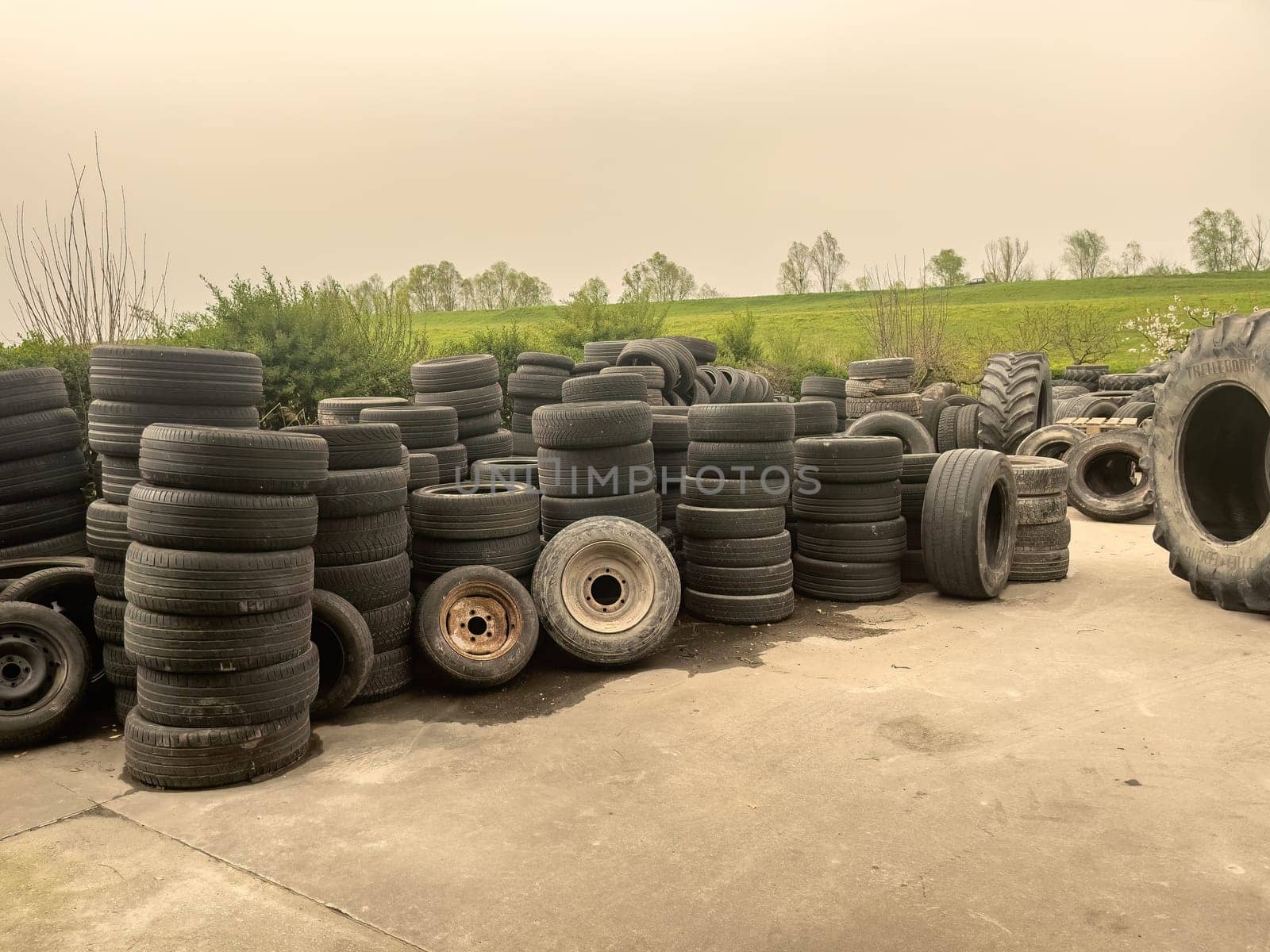 Piles of used tires ready for disposal. Environmental waste concept.