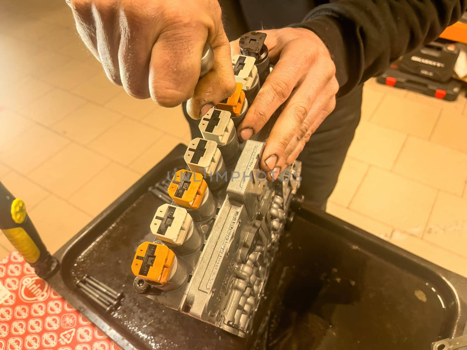 Close-up of solenoid valves in an automatic gearbox undergoing repair work.