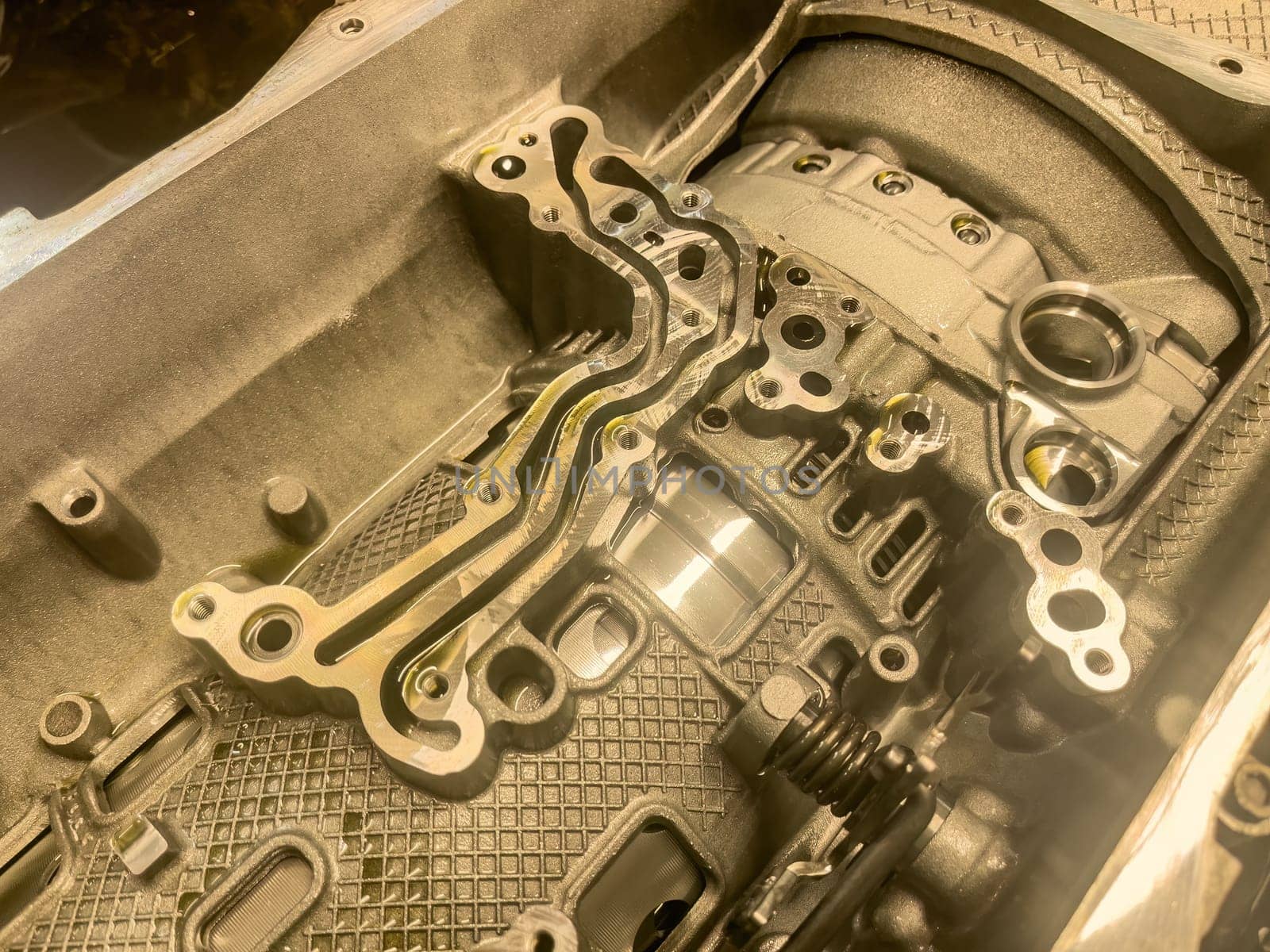 Close-up of mechanical repairs on an automatic gearbox during servicing or refurbishment.