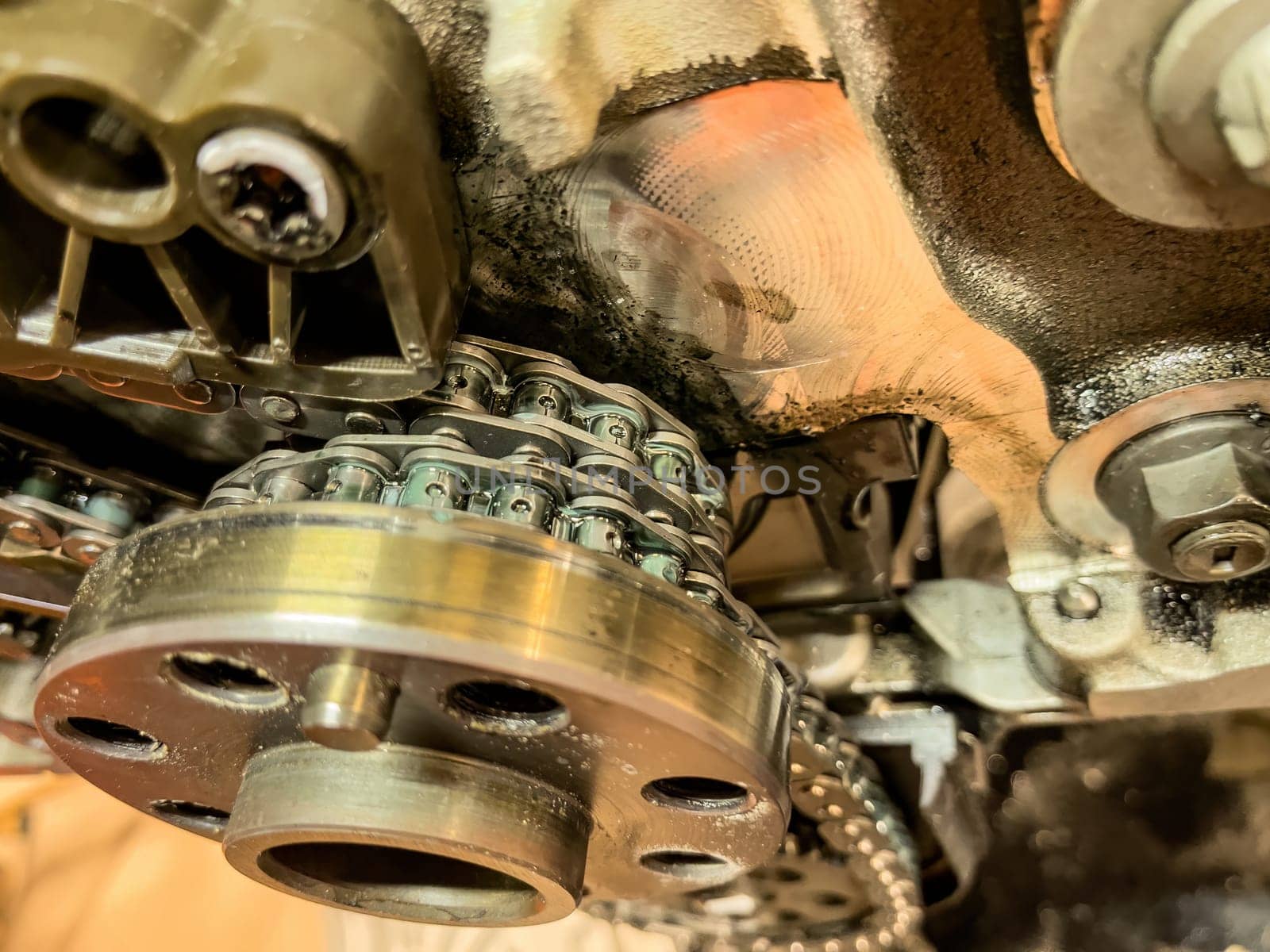 Close-up view of the timing chain inside a car engine.