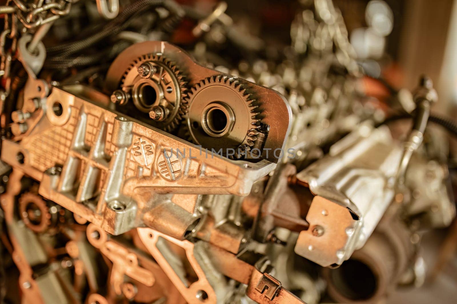 Close-up of mechanical car engine parts in an auto repair workshop.