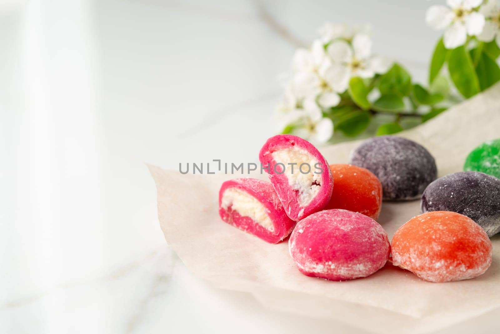 Multi-colored Japanese cakes Mochi in a white plate close up