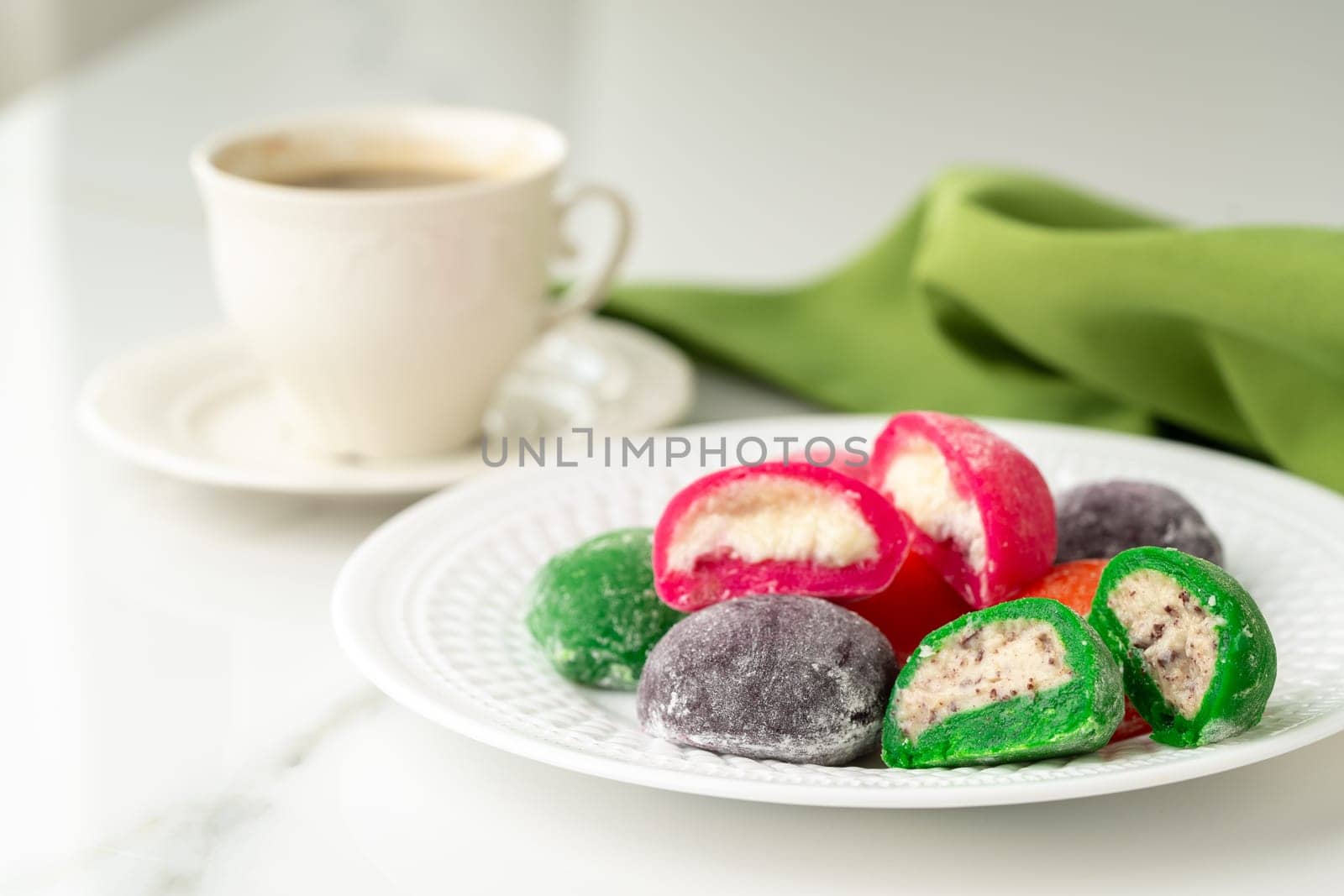 Multi-colored Japanese cakes Mochi in a white plate close up