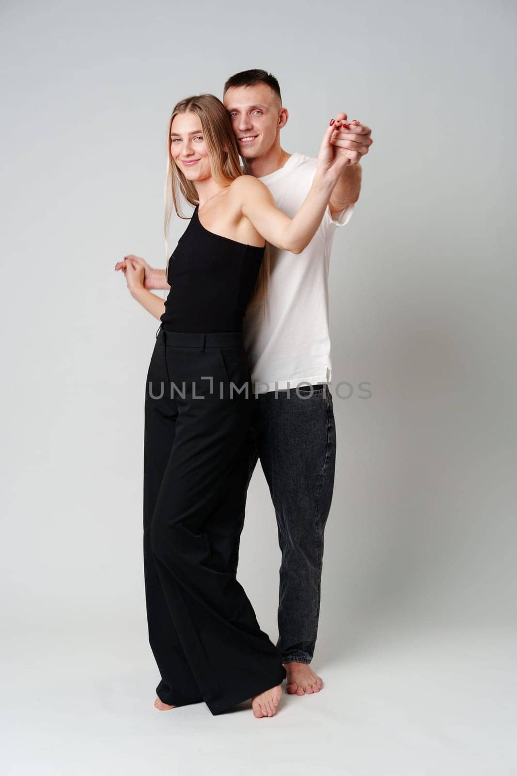 A Man and a Woman Standing Next to Each Other in studio posing