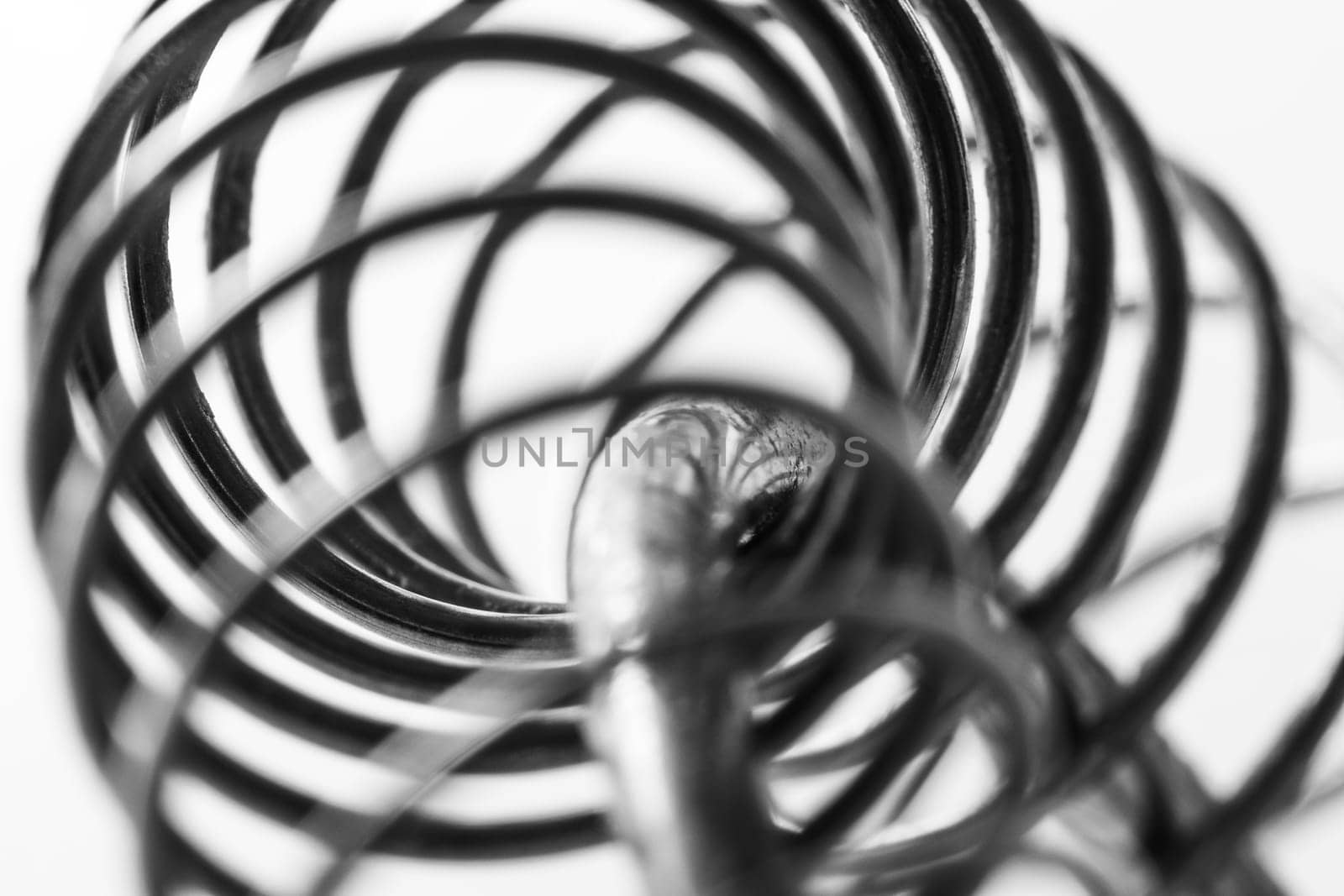 Metal spring coiled, black and white macro shot by clusterx