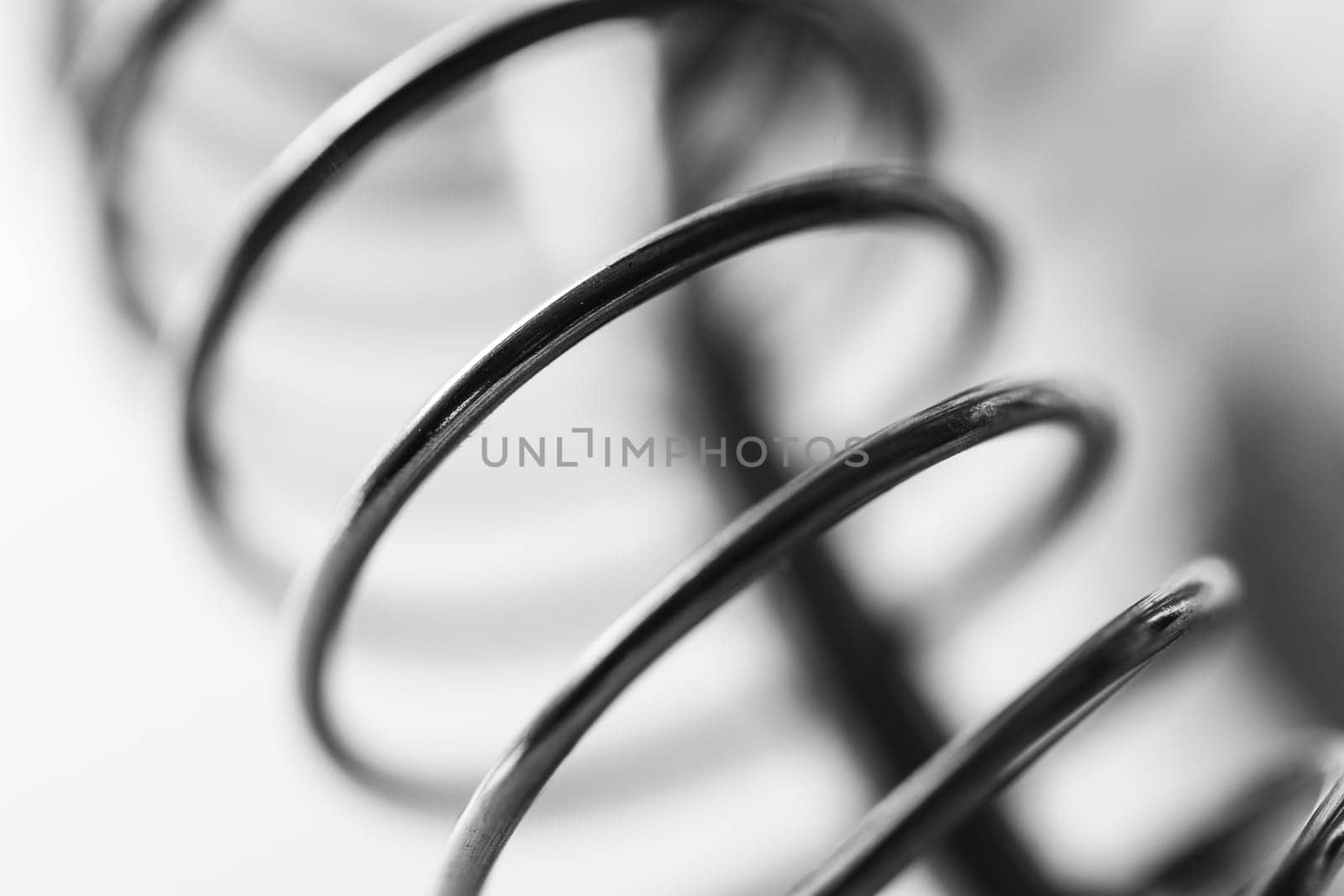 Metal spring coiled, black and white macro shot by clusterx