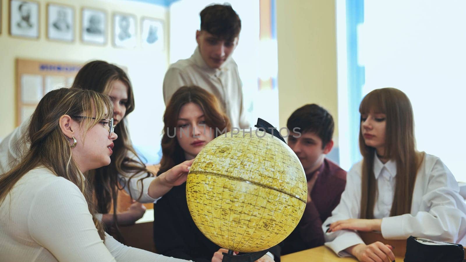 High school students looking at the yellow globe of the moon