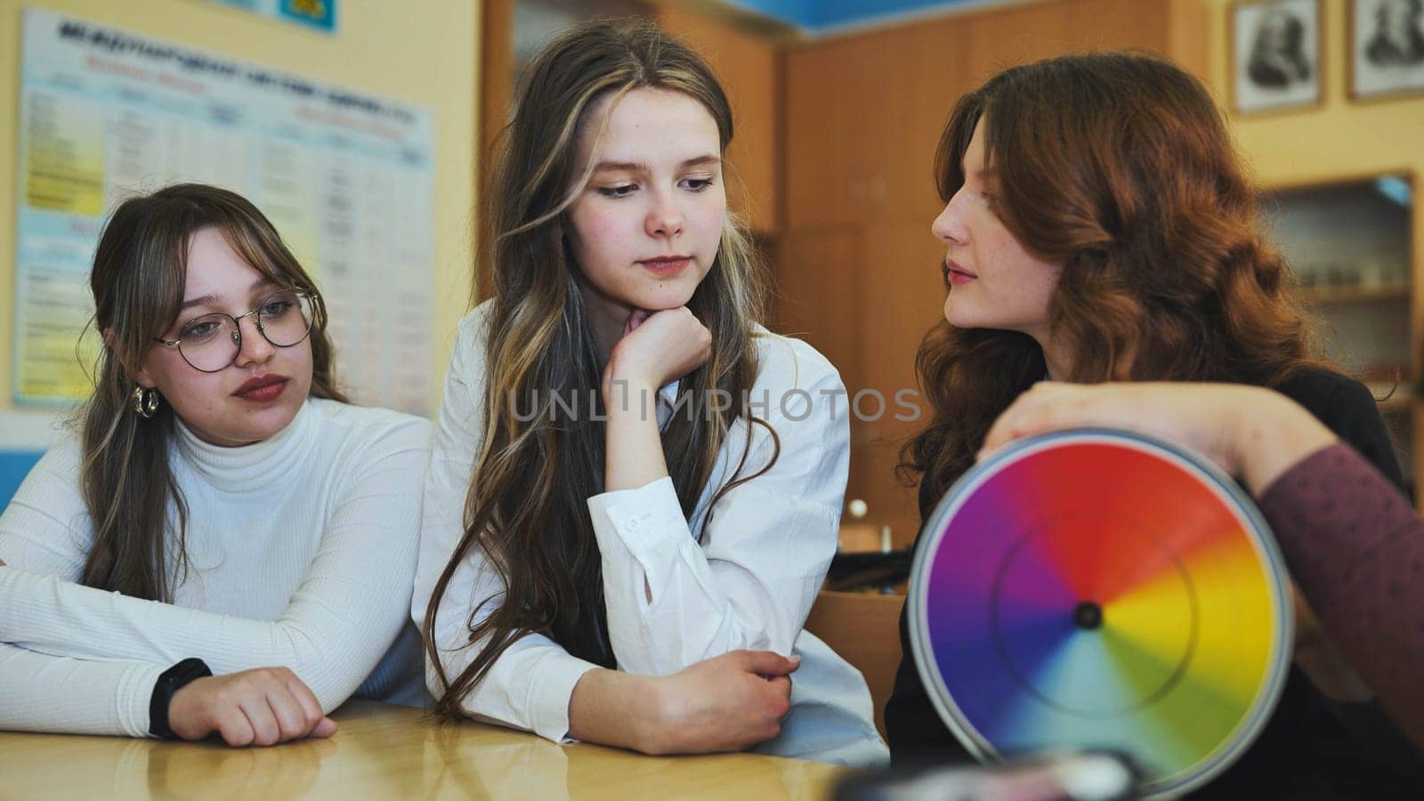 Students in physics class spin Newton's multicolored disk. by DovidPro