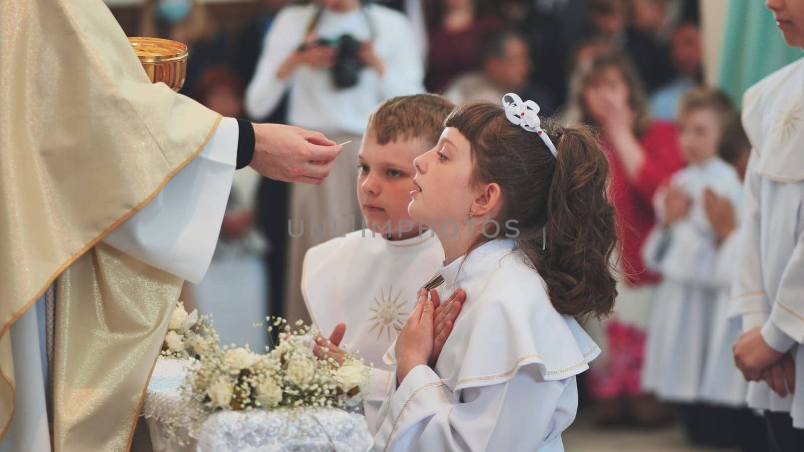 Lida, Belarus - May 31, 2022: Children going to the first holy communion. by DovidPro