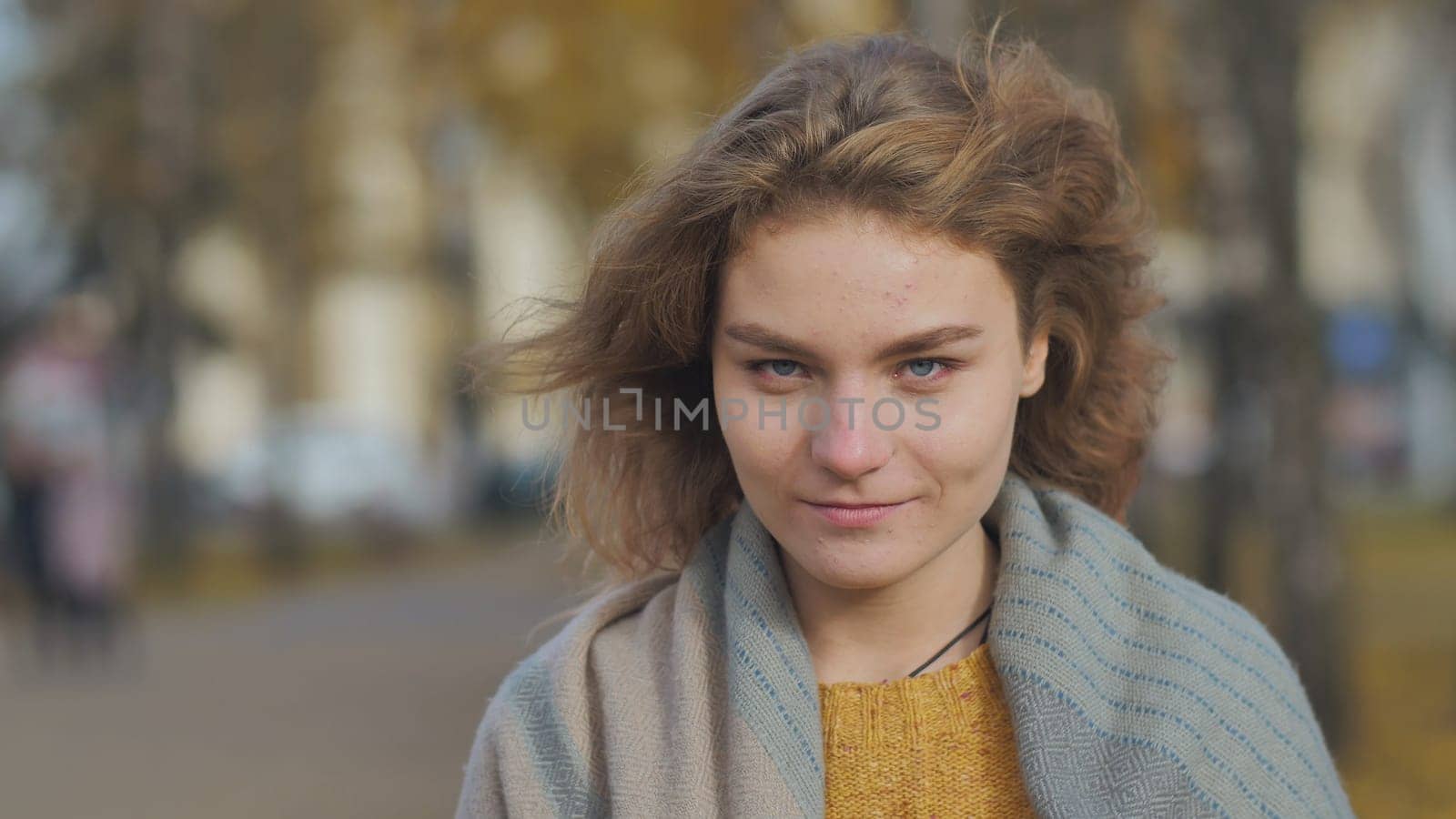 Portrait of a curly-haired redheaded girl outside by a tree. by DovidPro