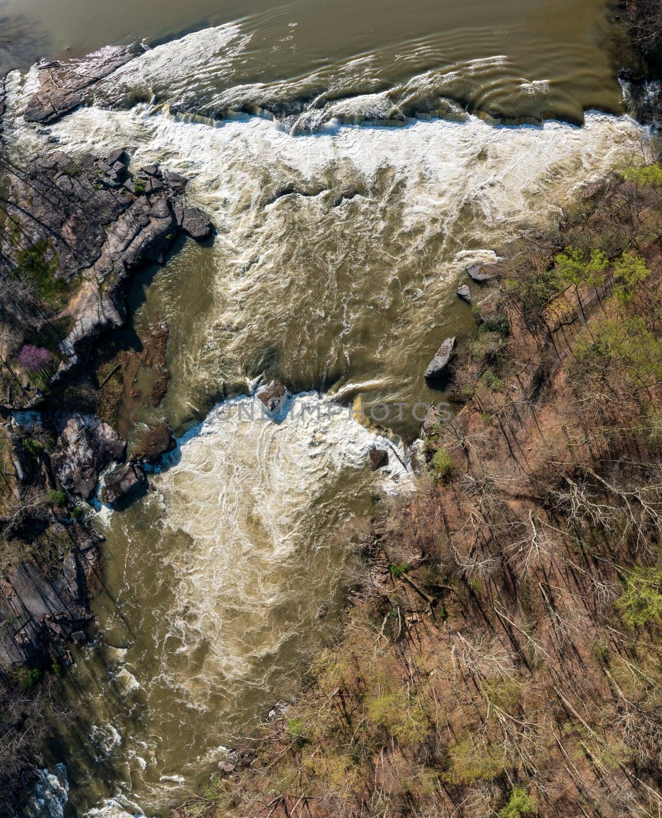 Top down over flooded Valley Falls on a bright spring morning by steheap