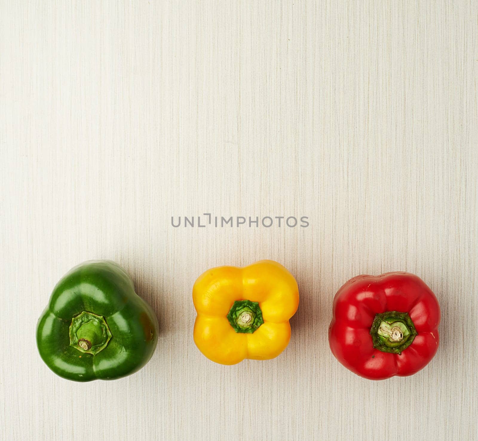 Vegetables, nutrition and bell pepper on table top for wellness, health and diet in studio. Ingredients, green and red isolated for eating, food and weight loss in house for prepare and cook. by YuriArcurs