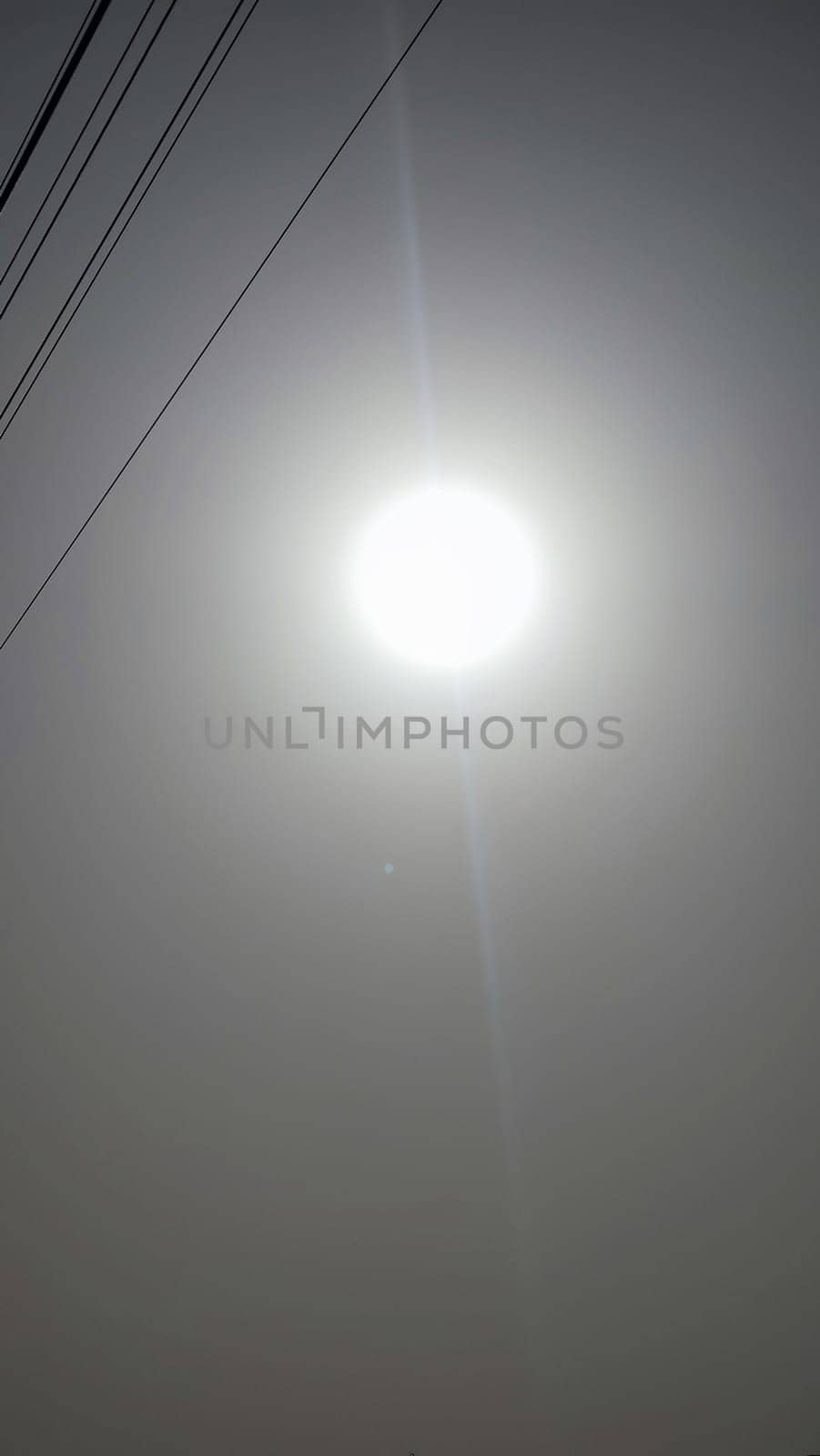 white sun in gray sky, weather background. High quality photo