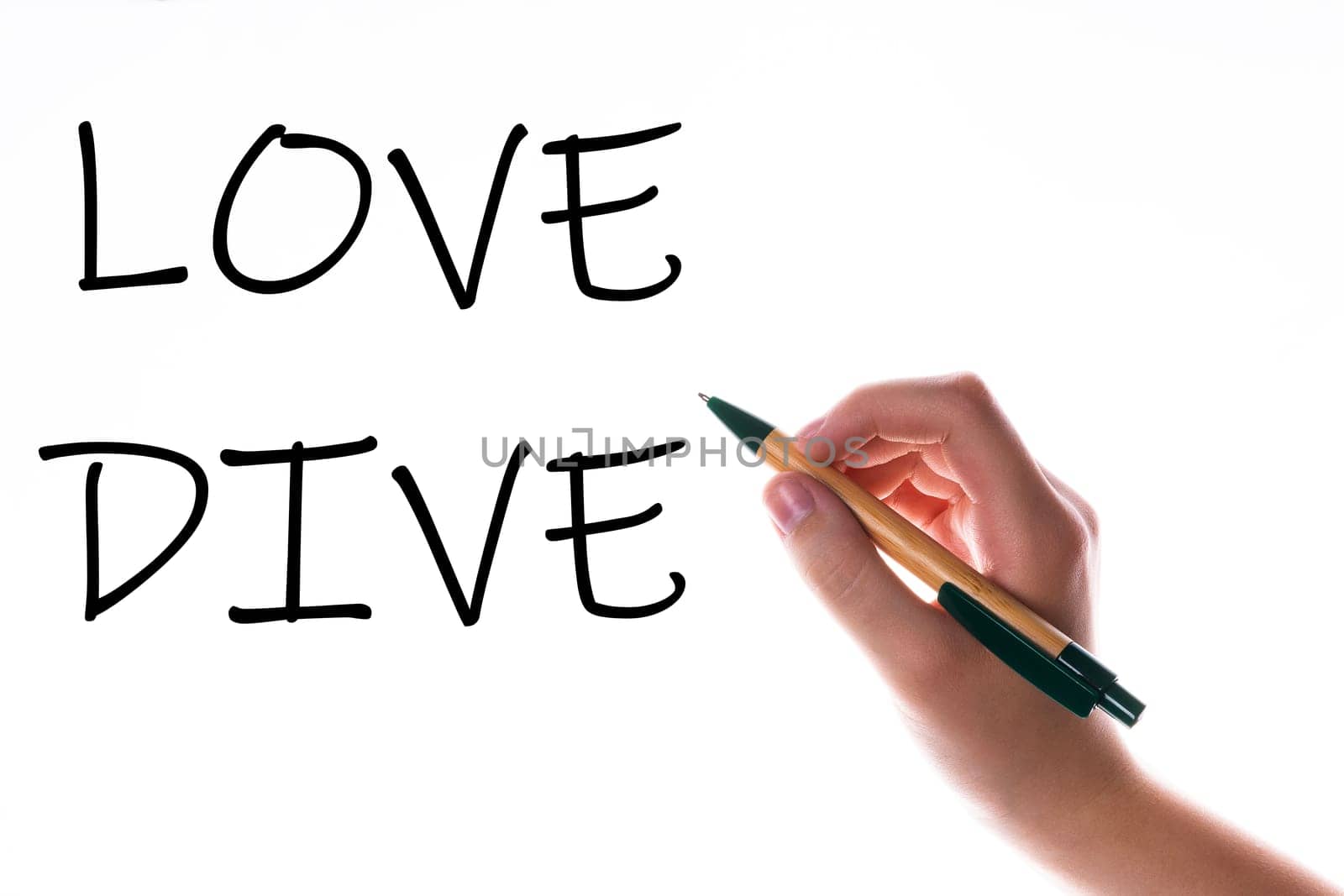 Children hand with pen write on a blue white background. Writing hand. Word Love Dive