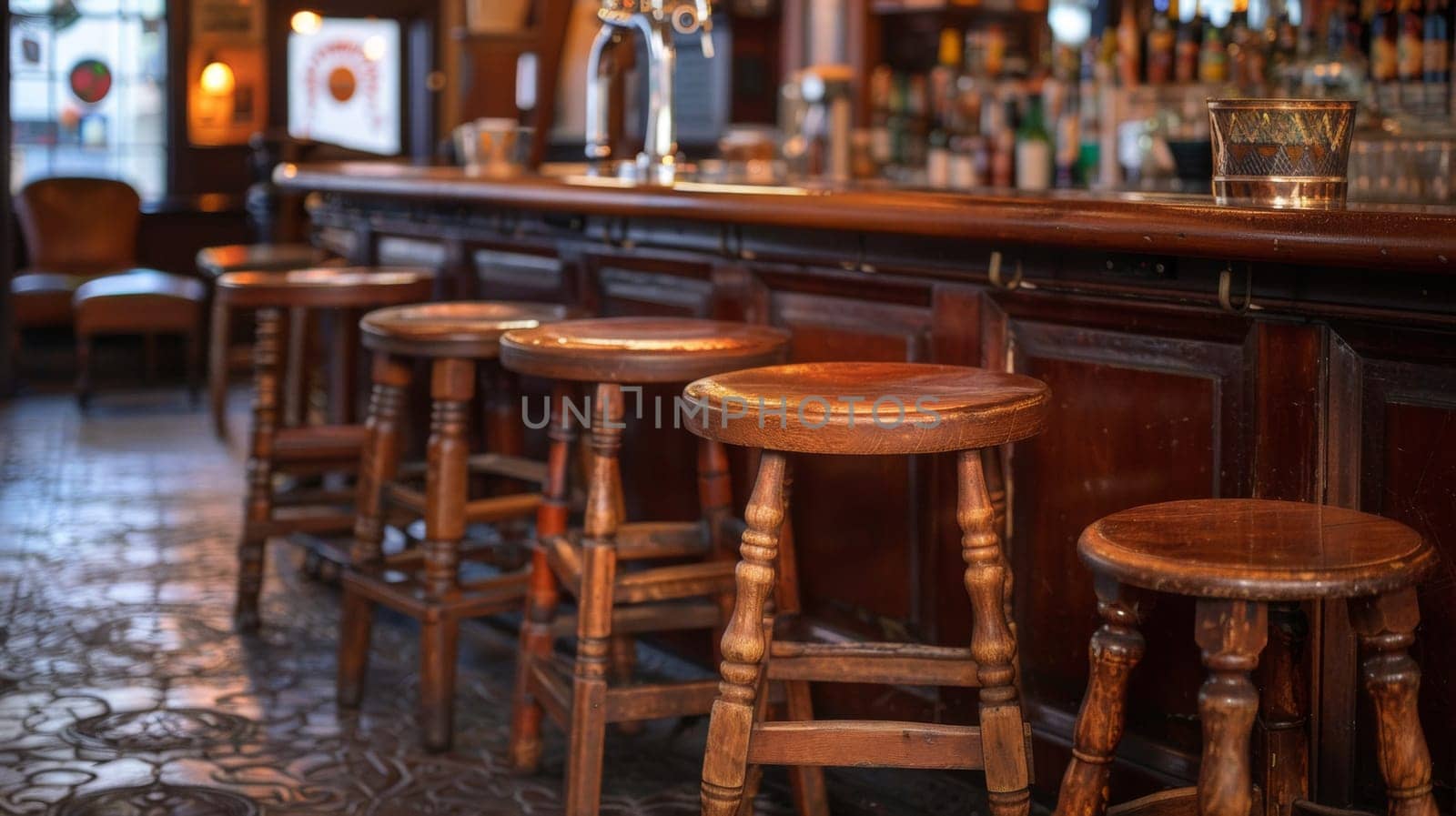 A row of wooden stools sit at a bar near the counter