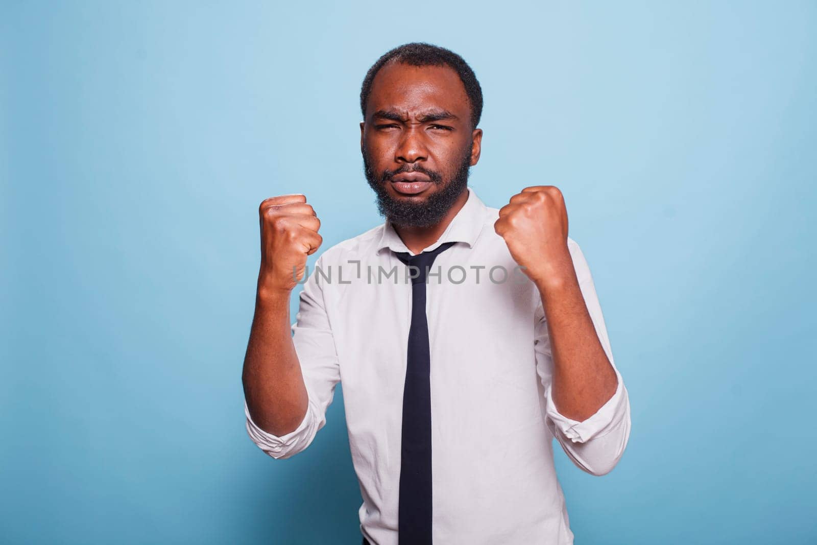 African american individual fighting with their problems at work having a combative demeanor Defensive black man boxing always on guard with intimidating posture fighting conflict for victory.